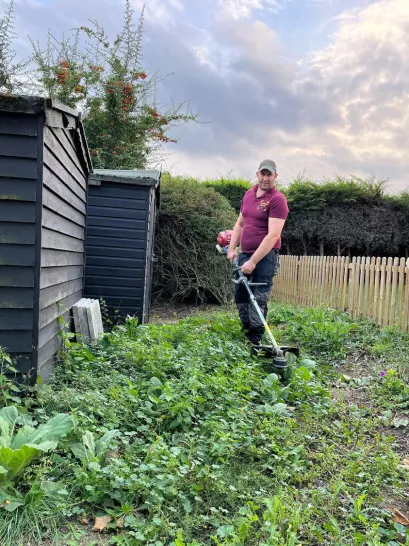 Tom cutting grass